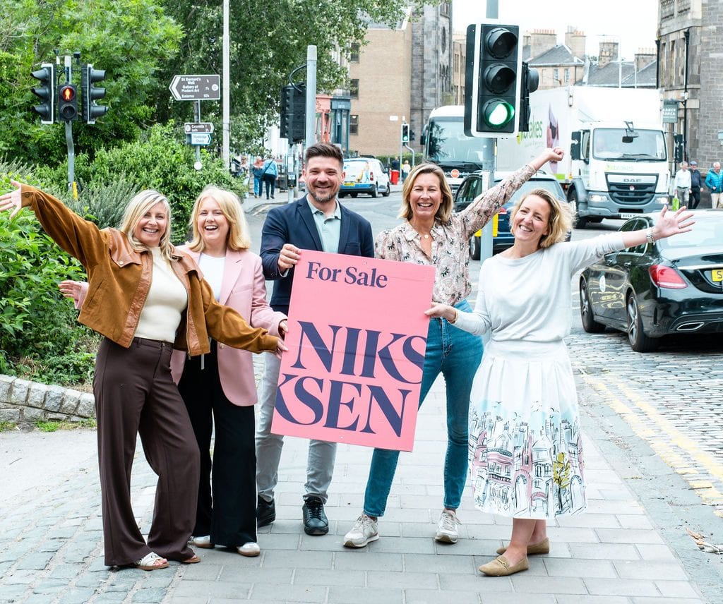 The Niksen team on an Edinburgh street with a Niksen For Sale board